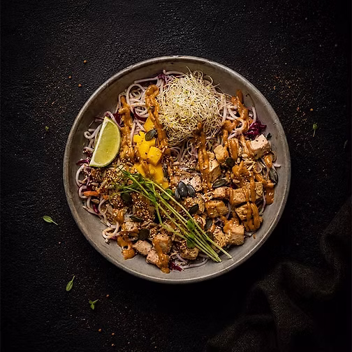 A colourful vegan bowl with tofu, vegetables, sprouts and lime from Fern & Fika in Hornstull