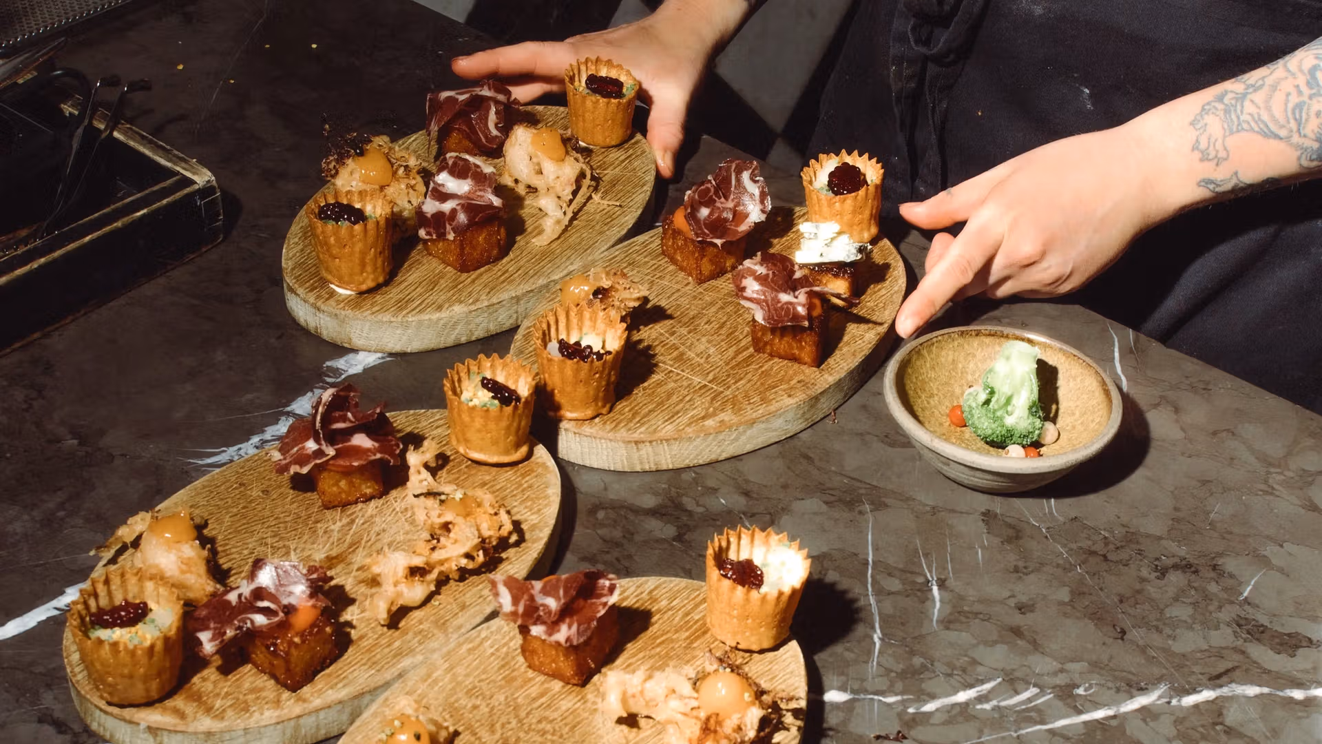 Brunch snacks arranged on wooden serving boards at Fotografiska in Stockholm