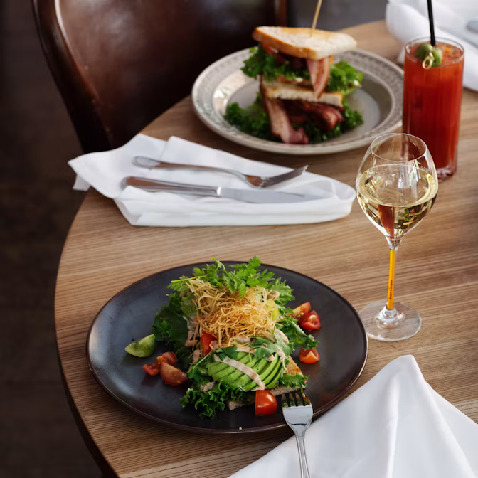 A sandwich and salad on a brunch table at Miss Clara in Stockholm