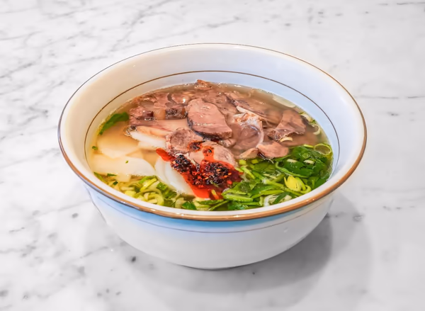 Beef noodle soup with sliced beef, greens and chilli at Ox Lan in Stockholm